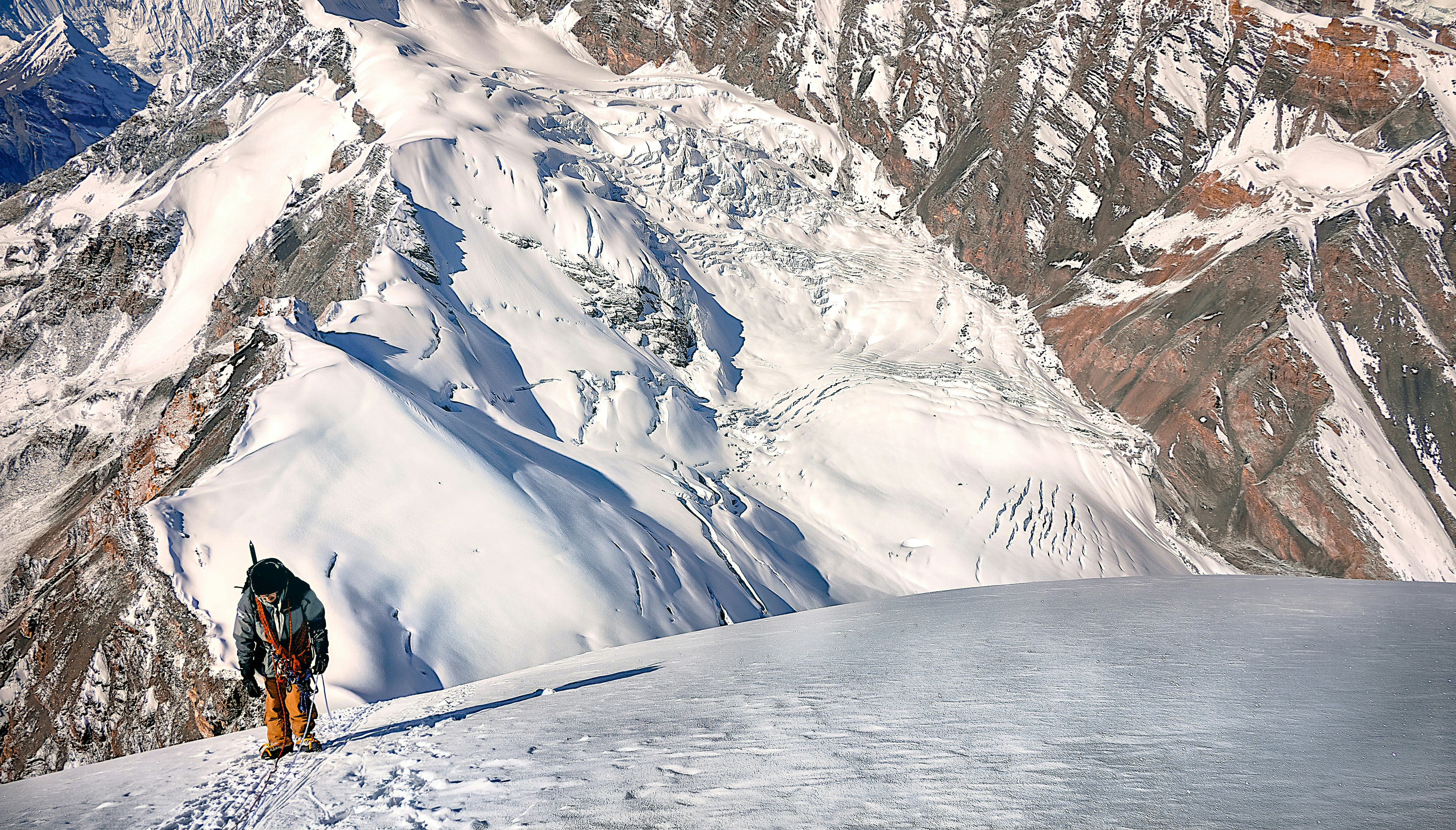 person standing on snow capped mountain